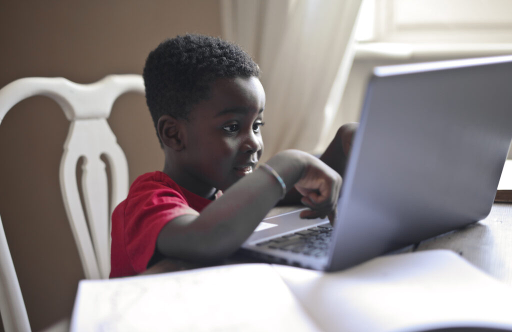 a kid coding with a laptop
